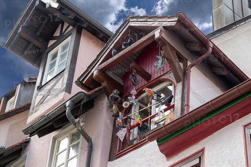 Historic roof lift bay window decorated with colourful figures, Villingen-Schwenningen, Baden-Württemberg, Germany, Europe
