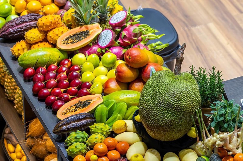 Exotic fruits, lychee, jackfruit, dragon fruit, mango and citrus fruits presented on a table, Germany, Europe