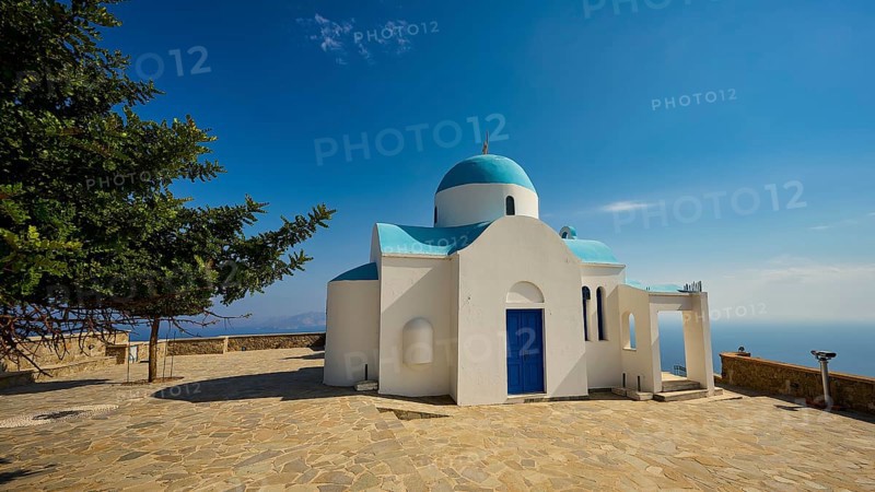 White-blue church with a tree next to it under a blue sky, Church of Profitis Ilias, above Nikia, Nikia, Nisyros, Dodecanese, Greek Islands, Greece, Europe