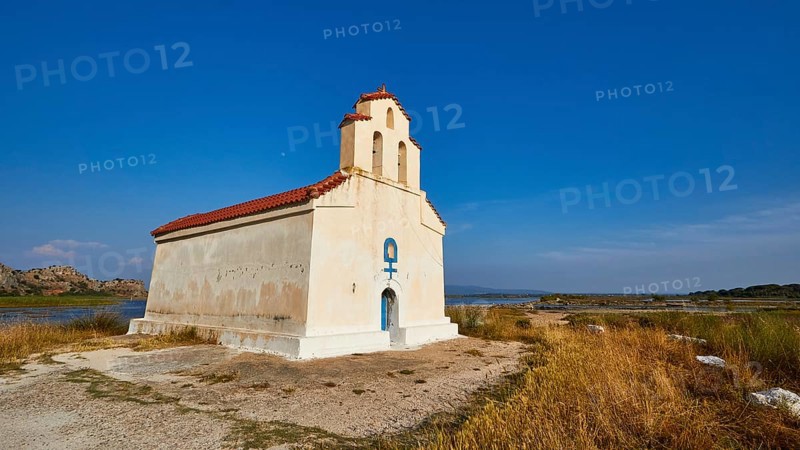 Agiou Petrou Chapel, Chapel of St Peter, Small church stands isolated under a clear blue sky next to a body of water, Strofilia biotope, wetlands, Kalogria, Peloponnese, Greece, Europe