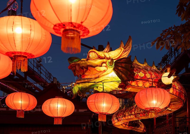Yellow glowing dragon and red lanterns at night, traditional Chinese decoration, Tivoli Amusement and Recreation Park, Copenhagen, Denmark, Europe