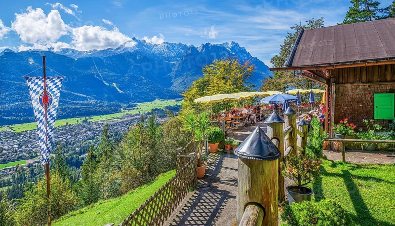 St. Martinshütte with restaurant terrace and view of the valley and Zugspitze group 2962m. Garmisch-Partenkirchen, Loisachtal, Werdenfelser Land, Upper Bavaria, Bavaria, Germany, Europe