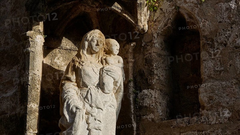 Church of Agia Triada, stone statue of a mother holding a child in an ancient and religious setting, Knights Street, Rhodes Old Town, Rhodes Town, Rhodes, Dodecanese, Greek Islands, Greece, Europe