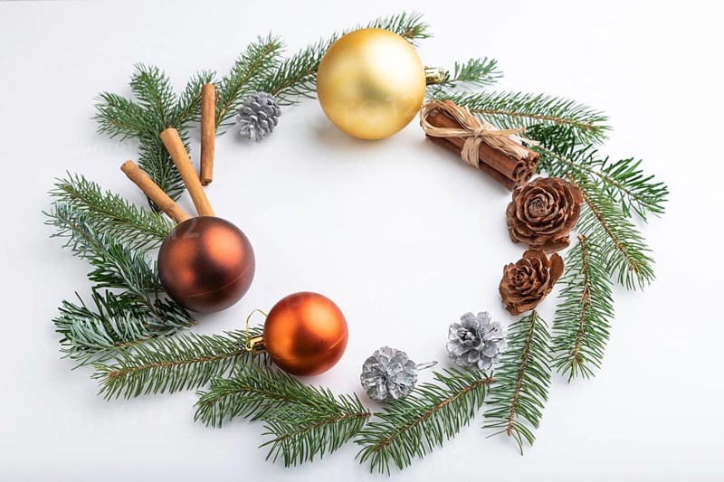 Christmas or New Year wreath composition. Decorations, balls, cones, fir and spruce branches, on white background. Side view, copy space