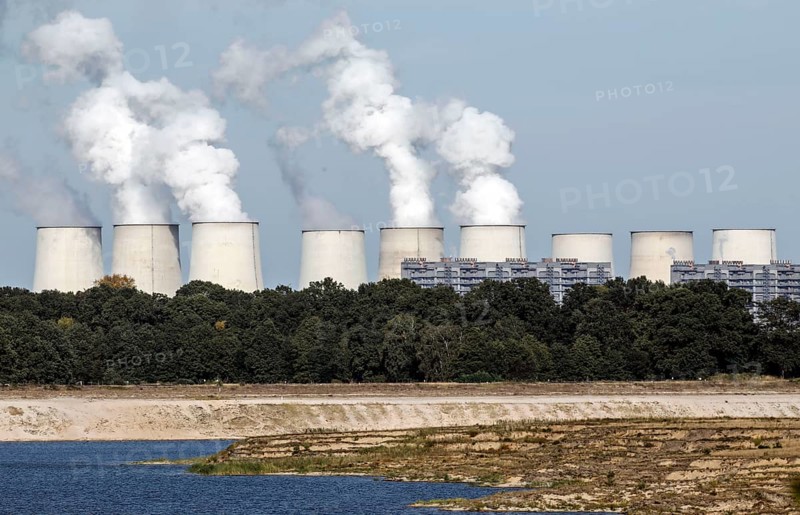 View from the Baltic Sea to the Jänschwalde lignite-fired power plant of LEAG Lausitz Energie Kraftwerke AG. The Cottbus Baltic Sea is a project in which the former Cottbus-Nord opencast lignite mine is flooded with water from the River Spree, Lakoma, 02/10/2021