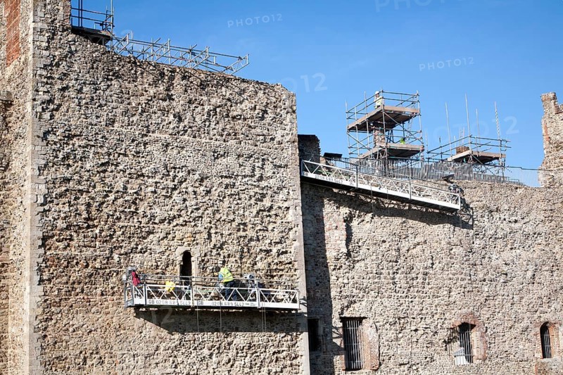Stonemasons doing maintenance repairs to the stone walls of Framlingham castle, Suffolk, England, United Kingdom, Europe