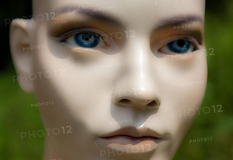 Female mannequin face doll model woman bald blue eyes close-up