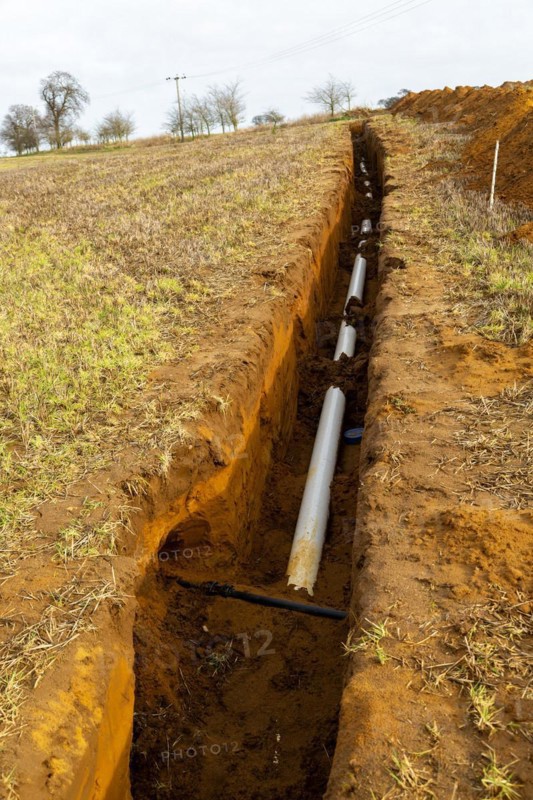 Farm irrigation water supply pipeline excavated in sandy soil, Shottisham, Suffolk, England, UK