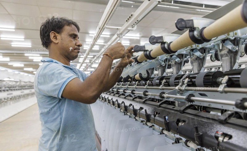 BENIN TEXTILE CORPORATION BENIN. processing cotton in a spinning mill factory near Cotonou in Benin, Glo-Djigbe, 07/03/2024. threading a yarn on a spinning machine