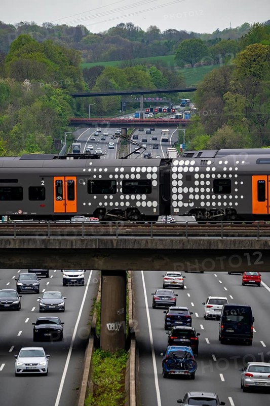 Rhine-Ruhr-Express, RRX train crossing the A3 motorway, traffic on 8 lanes, including the temporarily released hard shoulder, behind the Hilden motorway junction, view in north direction, near Erkrath, North Rhine-Westphalia, Germany, Europe