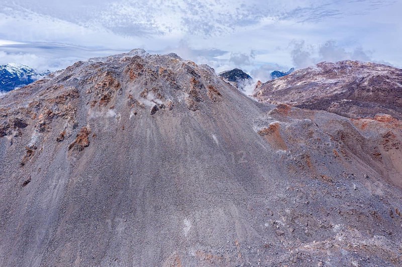 Vapors rise high at the summit of the Chaiten volcano, colorful rock formation, Park Pumalin, Patagonia, Chile, South America