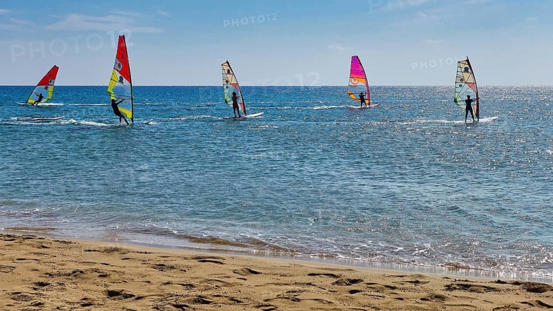 Windsurfer on the sea in sunny weather with colourful sails, surfer's paradise, kitesurfer, windsurfer, Prasonisi, island in the south of Rhodes, Rhodes, Dodecanese, Greek Islands, Greece, Europe
