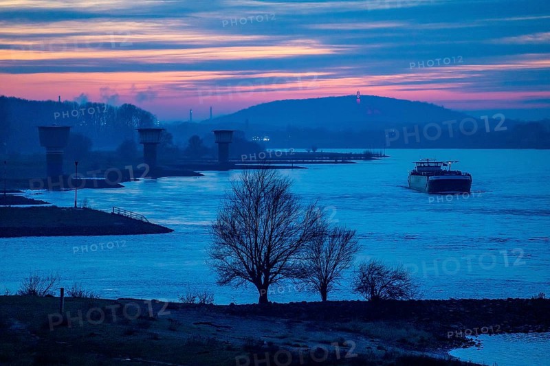 Rhine at Duisburg-Bruckhausen, towers of the water extraction facilities of ThyssenKrupp Steel steelworks, cargo ship, winter, Duisburg, North Rhine-Westphalia, Germany, Europe