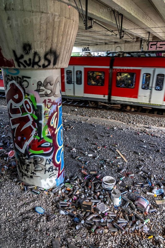 Empty spray paint cans, on a railway line below a road bridge, thrown away, disposed of by the sprayer, graffiti, rubbish heap, Essen, North Rhine-Westphalia, Germany, Europe