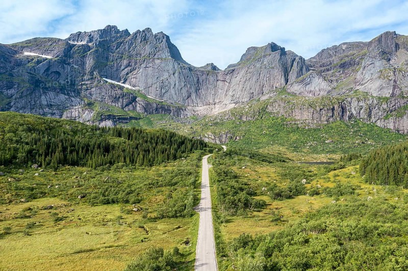 Aerial view of road in mountain scenery, passing lakes and meadows, road from E10 to village Nusfjord, Lofoten, Norway, Europe