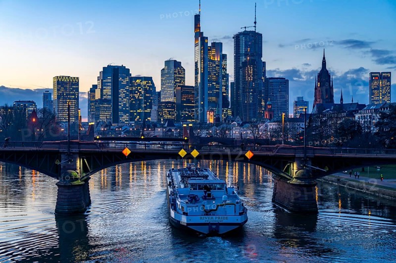 Skyline of the city centre of Frankfurt am Main, river Main, dusk, Ignatz-Bubis-Bridge, cargo ship, tanker, Hesse, Germany, Europe