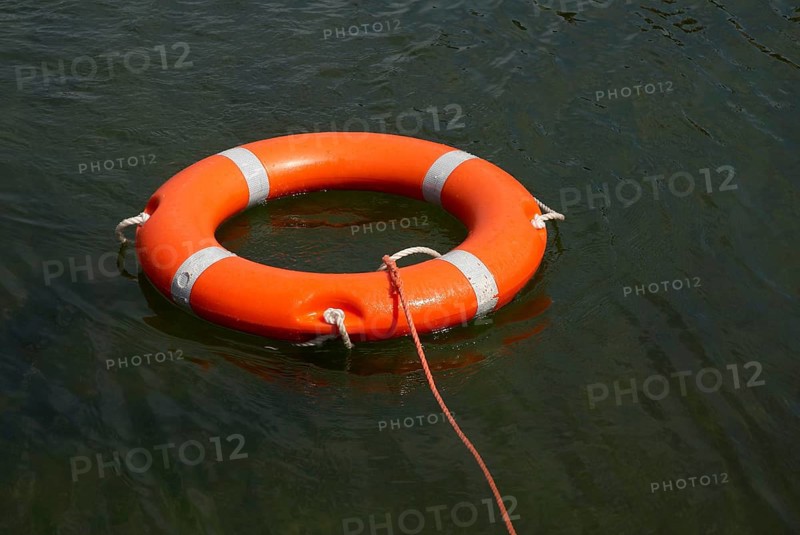 Lifebuoy with lifeline in the water, distress at sea, drowning, accident, danger, shipping, seafaring, rescue