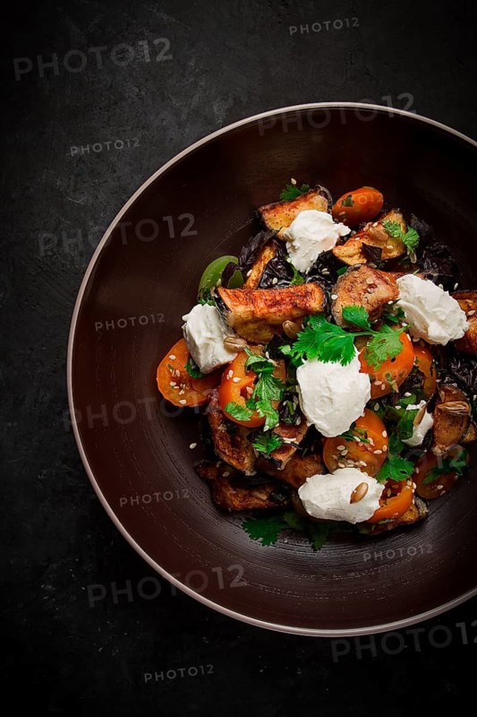 Warm Salad with crispy eggplant and tomatoes, cottage cheese, spices, herbs, sesame seeds, sunflower seeds, Georgian cuisine, no people