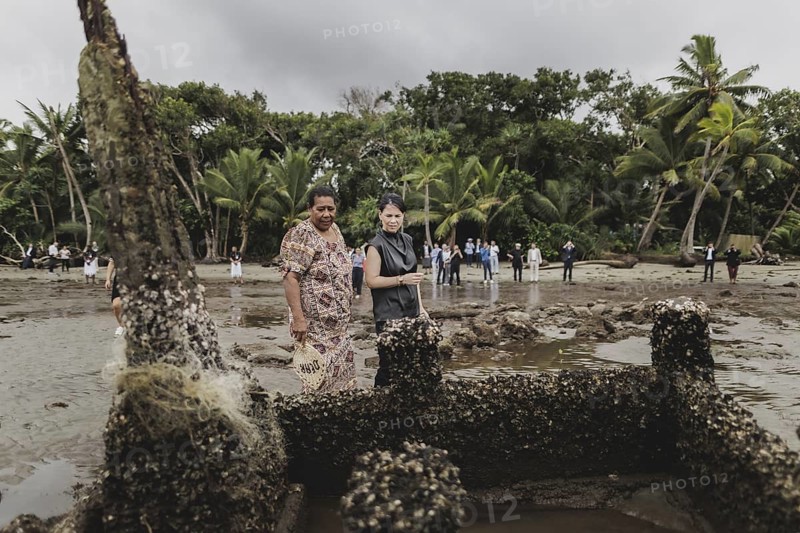 (R-L) Annalena Bärbock (Bündnis 90/Die Grünen), Federal Foreign Minister, and Lavenia McGoon, resident of the Togoru settlement, photographed during a briefing on coastal erosion at a cemetery near the Togoru settlement flooded by rising sea levels, 07.05.2024. Bärbock is travelling to Australia, New Zealand and Fiji for political talks / Photographed on behalf of the Federal Foreign Office
