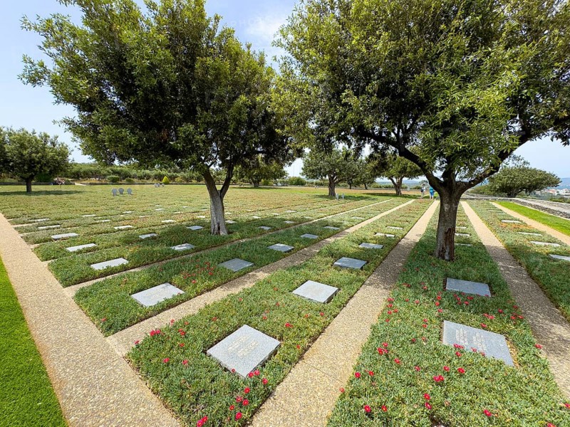 Olive trees (Olea europaea) stand between cast shadows on rows of grave slabs Gravestones Graves of German soldiers' graves on part of German War Graves Commission (Volksbund Deutsche Kriegsgräberfürsorge) German military cemetery inaugurated in 1974 on former battlefield in World War II heavily contested hill Height 107, Maleme, Crete, Greece, Europe