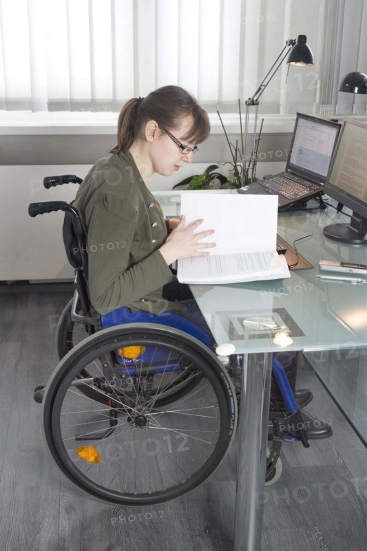Young woman in a wheelchair at her workplace, Berlin, 18/01/2017