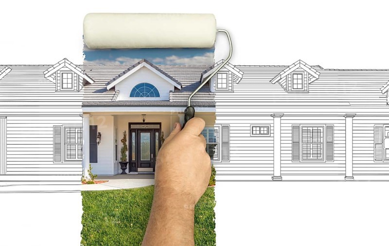 Before and after of man painting roller to reveal custom home photograph under pencil sketch drawing plans