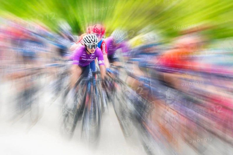 Cyclist in sportswear and helmet riding at high speed on a road, race, the motion blur emphasises the speed, Stuttgart, Baden-Württemberg, Germany, Europe