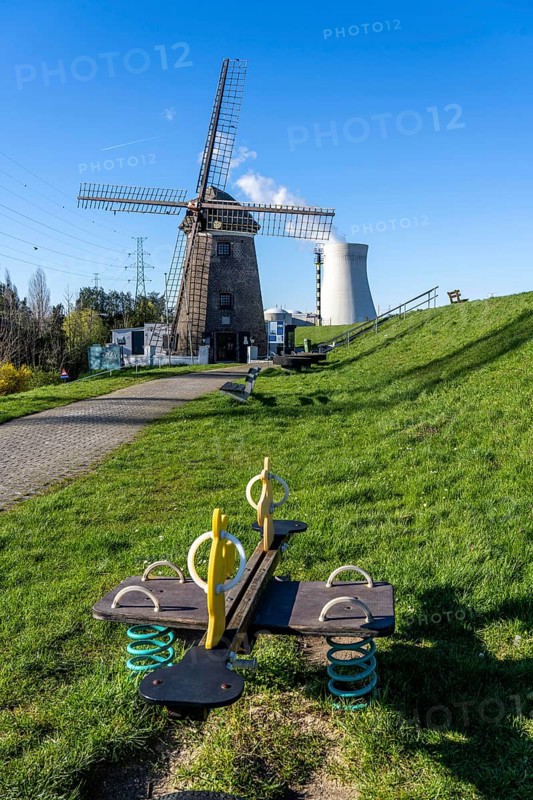 The Doel nuclear power plant on the Scheldt, one of two nuclear power plants in Belgium, consists of three operating units, each with a pressurised water reactor, as well as a decommissioned unit, historic Scheldemolen, windmill on the Scheldt dike, Antwerp, Belgium, Europe
