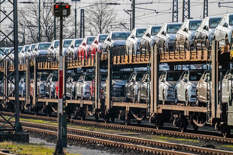 VW plant, Emden, new cars, car transporter, car train, goods train, with VW vehicles, Lower Saxony, Germany, Europe