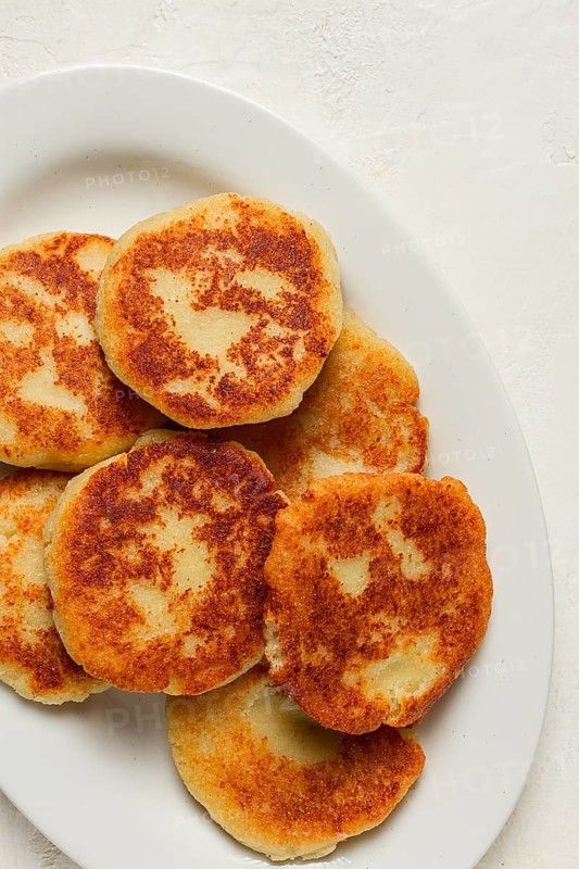 Chvishtari, corn flour tortillas with cheese, pastries, Georgian cuisine, Mchadi, homemade, top view, on a wooden table, no people