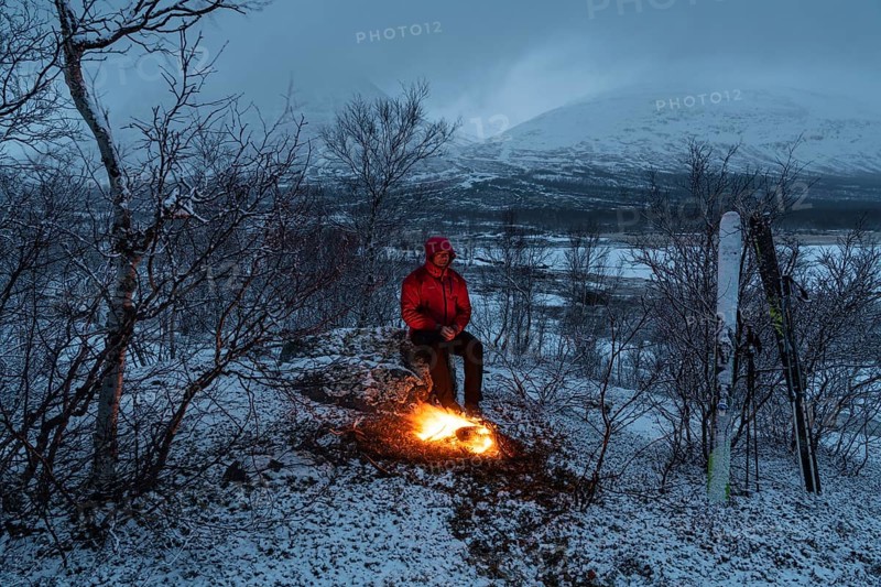 Man at the campfire, Stora Sjöfallet National Park, World Heritage Laponia, Norrbotten, Lapland, Sweden, April 2018, Lapland, Sweden, Europe