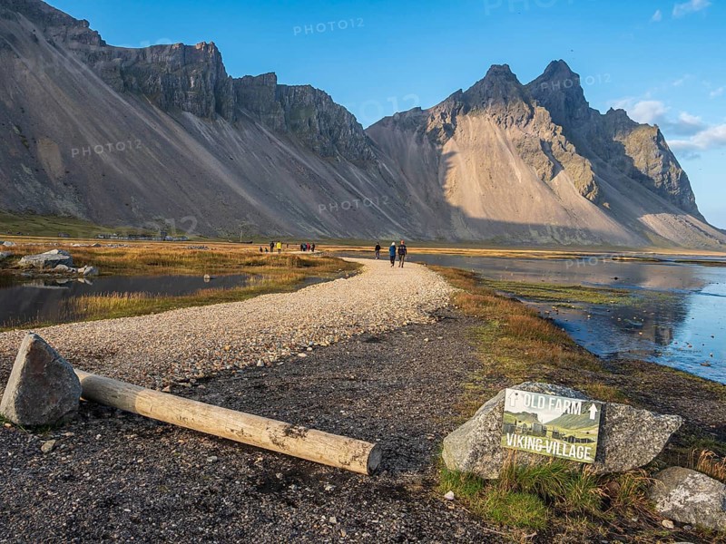 Tourists on path to viking village, rebuild viking houses at Stokksnes, east of Höfn, East Fjords, Iceland, Europe