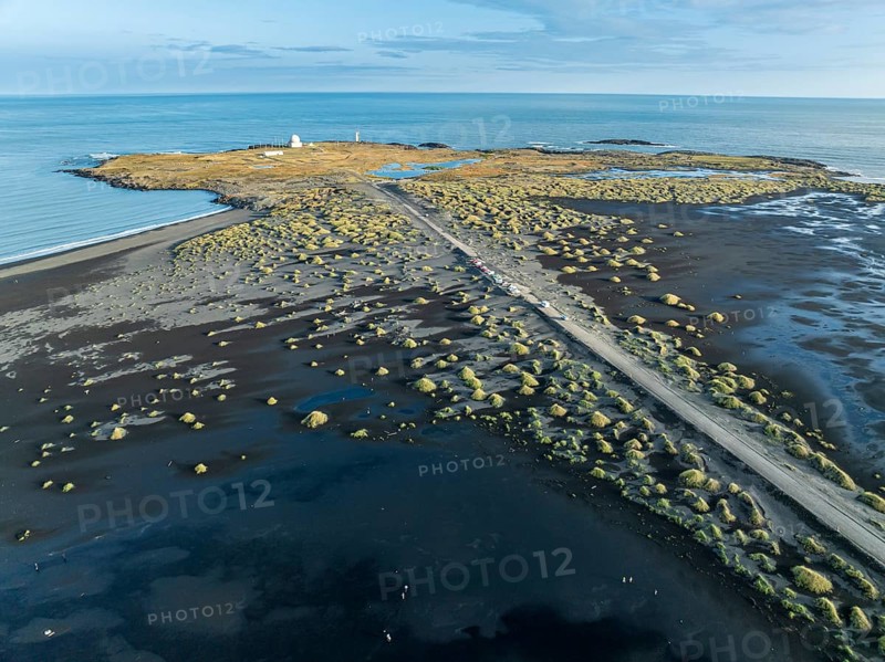 Aerial view of black lava beach, lighthouse and NATO radar station, Stokksnes, east of Höfn, East Fjords, Iceland, Europe