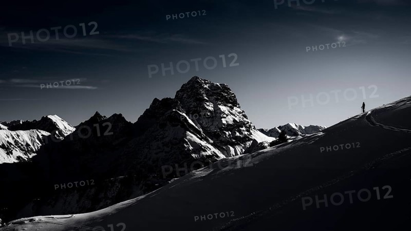 Mountaineers in front of the summit of the Großer Widderstein in winter, Baad, Vorarlberg, Austria, Europe