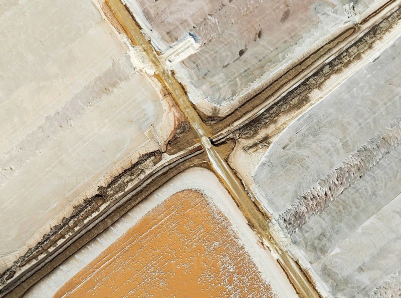 Saline ponds at the Bonanza salt works near Sanlúcar de Barrameda. The reddish colour depends on the level of salinity and is directly caused by the algae Dunaliella salina and brine shrimp. Aerial view. Drone shot. Cádiz province, Andalusia, Spain, Europe