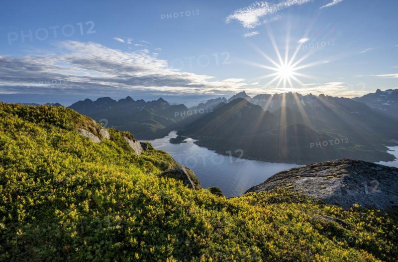 View of Fjord Raftsund and mountains in the evening light, sun star, view from the top of Dronningsvarden or Stortinden, Vesterålen, Norway, Europe