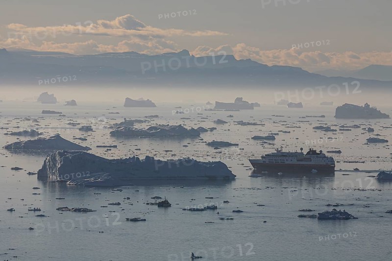 Hurtigruten ship sails through icebergs and ice floes, summer, midnight sun, Jakobshavn glacier and ice fjord, Ilulissat Kangerlua, Disko Bay, West Greenland, Greenland, North America