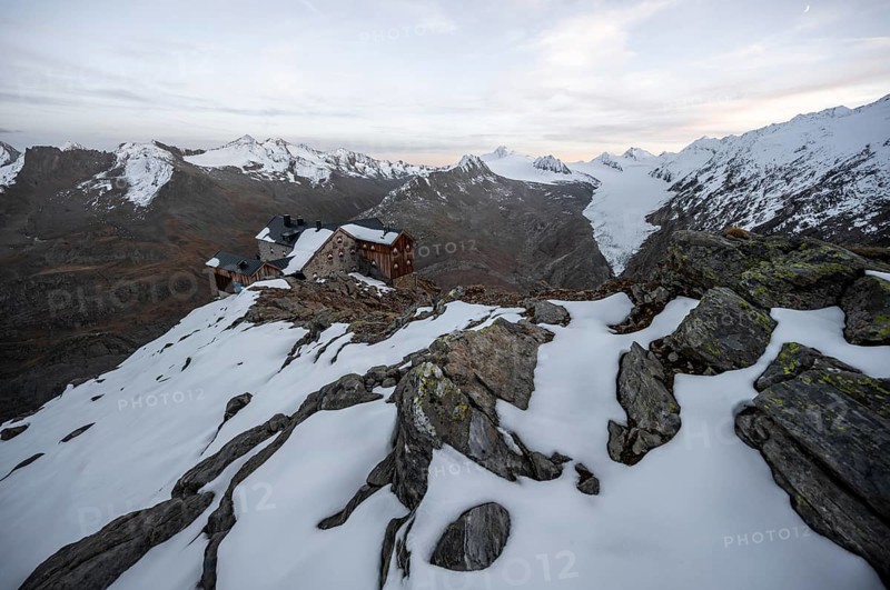 Snow-covered mountain landscape, mountain hut Ramolhaus in autumn with snow, at sunset, view of Gurgler Ferner with summit Hochwilde and Falschungsspitze, Ötztal Alps, Tyrol, Austria, Europe