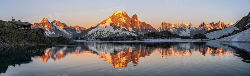 Evening mood, mountain landscape at sunset, alpenglow, water reflection in Lac Blanc with mountain hut Refuge du Lac Blanc, mountain peak, Aiguille Verte, Grandes Jorasses, Aiguille du Moine, Mont Blanc, Mont Blanc massif, Chamonix-Mont-Blanc, Haute-Savoie, France, Europe