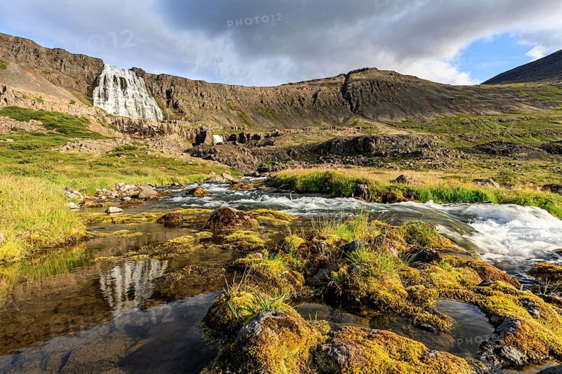Waterfall reflected in water, Flu, sunny, cloudy mood, midnight sun, mountains, Dynjandi, Westfjords, Iceland, Europe