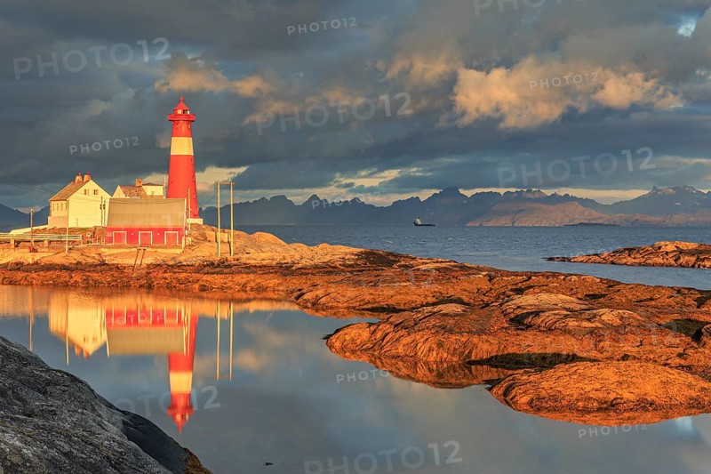 Lighthouse reflected in water, morning light, clouds, mountains, coast, Tranoy, Ofoten, Norway, Europe