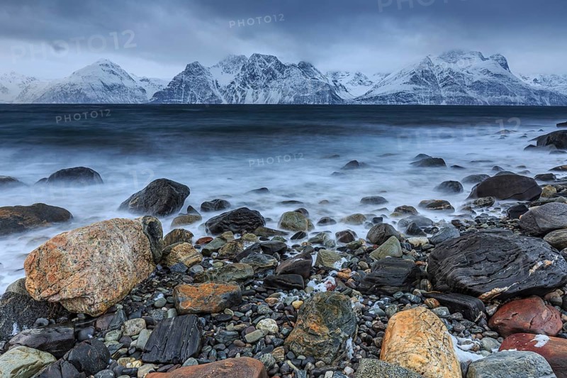 Stones, coast, sea, waves, mountains, winter, snow, cloudy, windy, long exposure, Lyngen Alps, Norway, Europe