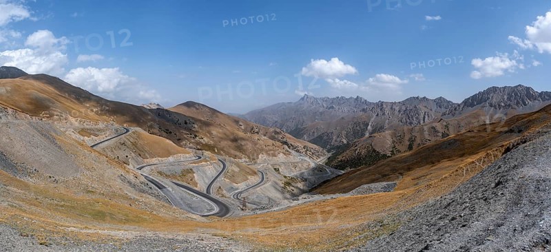 Winding roads on the Pamir Highway, mountain road through an eroded mountain landscape, Kyrgyzstan, Asia