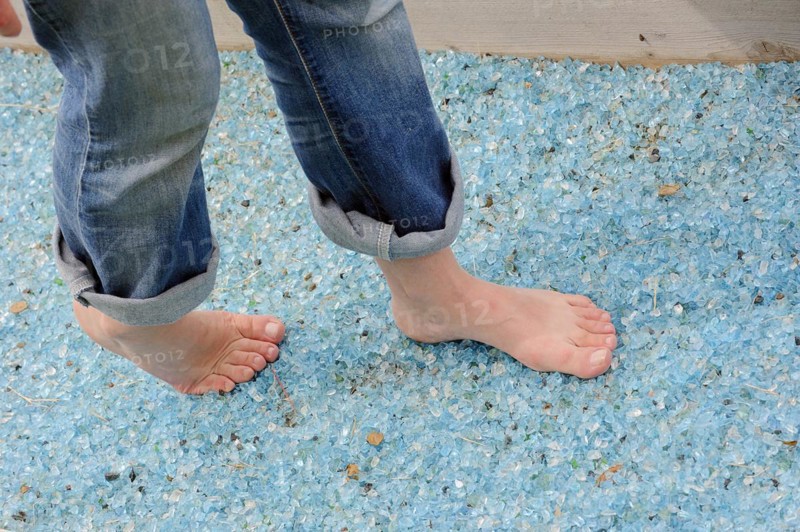 Woman walking barefoot over broken glass, glass gravel barefoot path, Tilbeck Abbey, Havixbeck, North Rhine-Westphalia, Germany, Europe