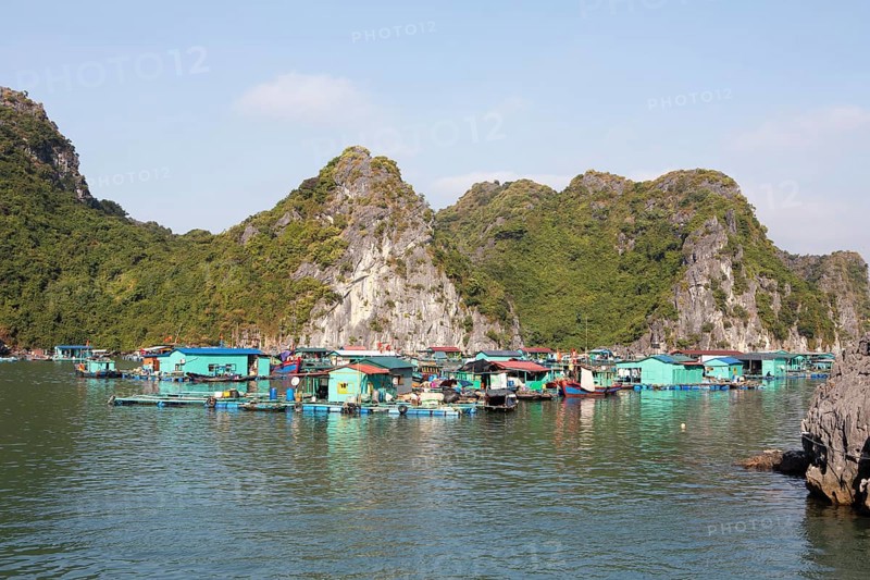 The floating fishing village of Cai Beo and the karst rocks in Lan Ha Bay, Halong Bay, Vietnam, Asia