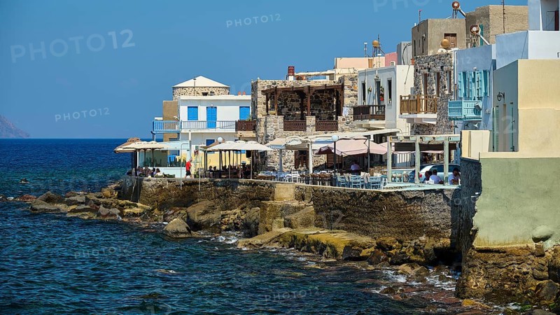 Picturesque coastal village with houses and balconies on the blue water, sunny atmosphere, Mandraki, Nisyros, Dodecanese, Greek Islands, Greece, Europe