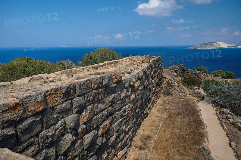 Ruin wall in an arid landscape with a view of the sea and a coastline in the background, Palaiokastro, Ancient fortress, 3rd and 4th century BC, above Mandraki, Nisyros, Dodecanese, Greek Islands, Greece, Europe