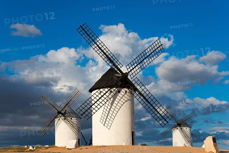Three windmills stand in an open landscape under a cloudy but sunny sky, Windmills, Campo de Criptana, Ciudad Real province, Castilla-La Mancha, Route of Don Quixote, Spain, Europe
