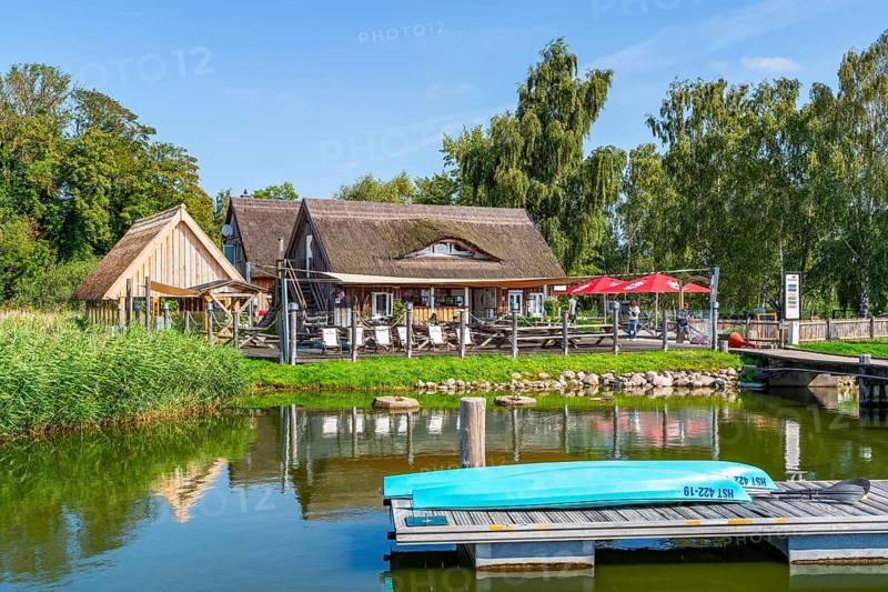 Canoes and thatched houses in Krummin natural harbour, Krumminer Wiek on the Peenestrom, Usedom Island, Mecklenburg-Western Pomerania, Germany, Europe