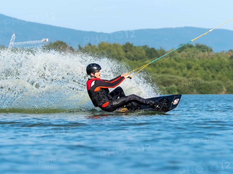 Young man doing sports with wakeboard in lake, water sports, water skiing in wakepark, Stráž pod Ralskem, Czech Republic, Europe